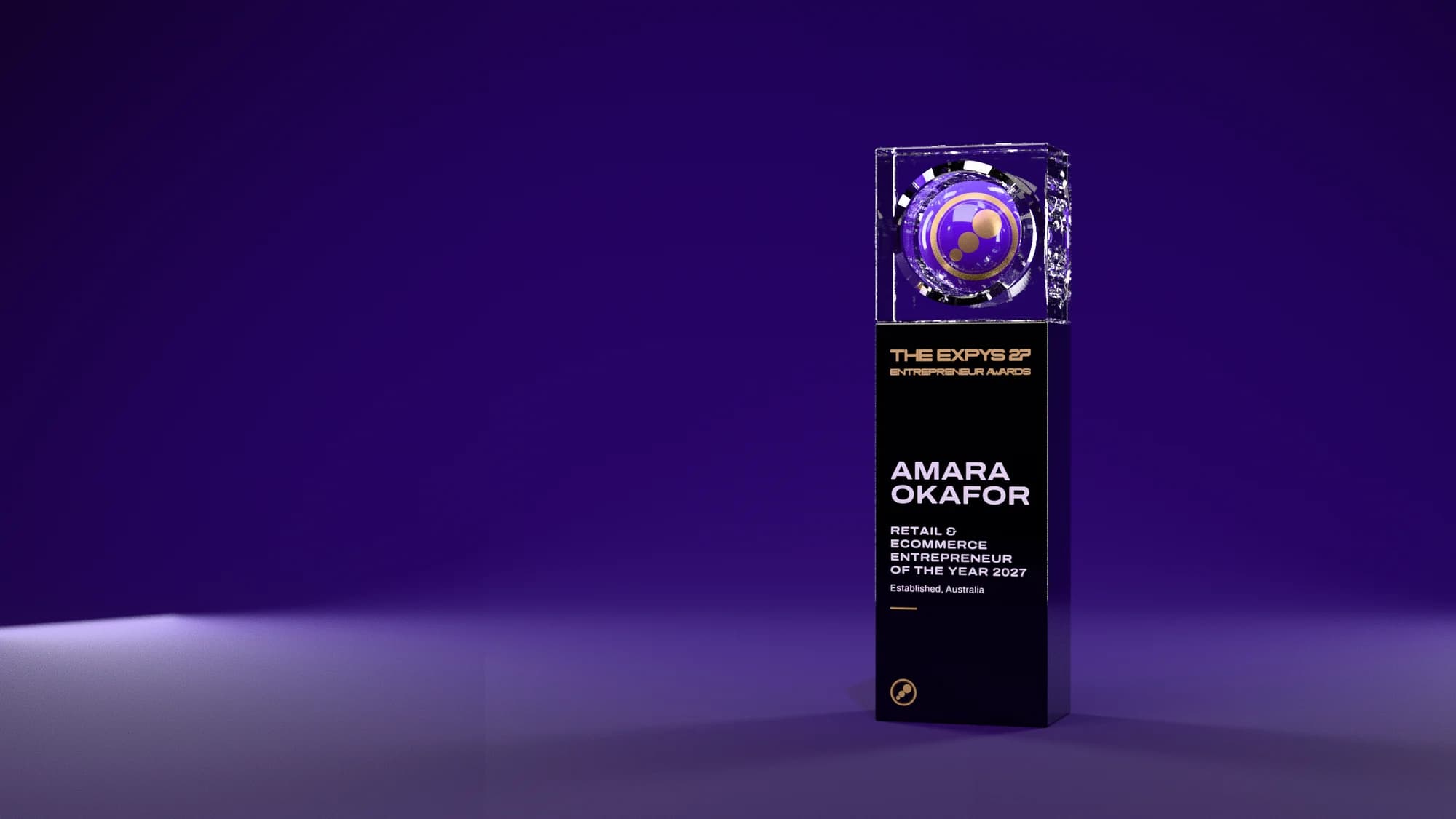 A single Expys 27 trophy for an Entrepreneur Awards winner under purple light