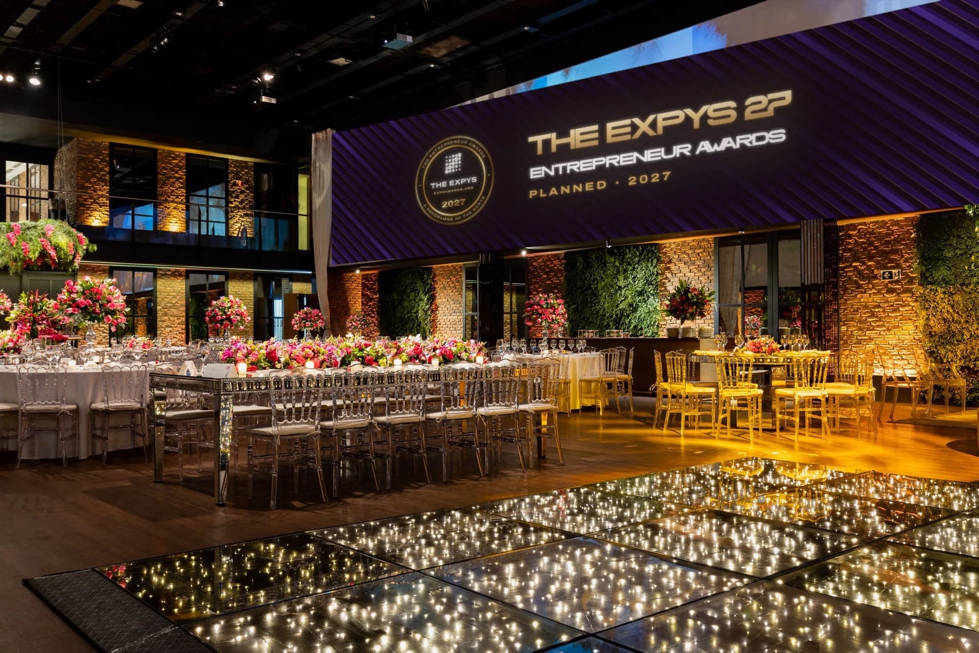 An Entrepreneur Awards room with a lit dance floor and the stage banner