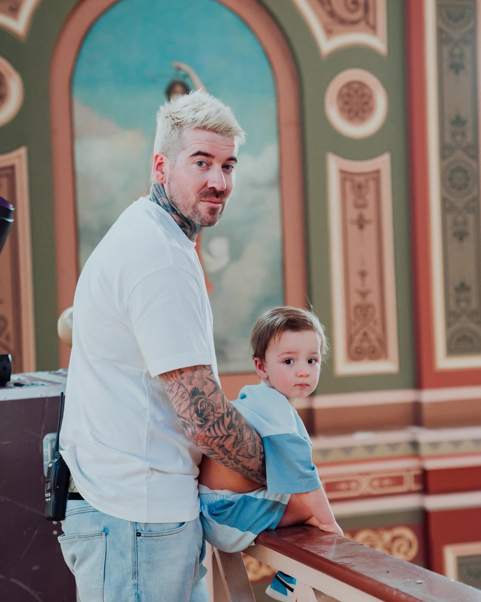 Kevin Mack holding his young son at the gallery rail of the Royal Exhibition Building