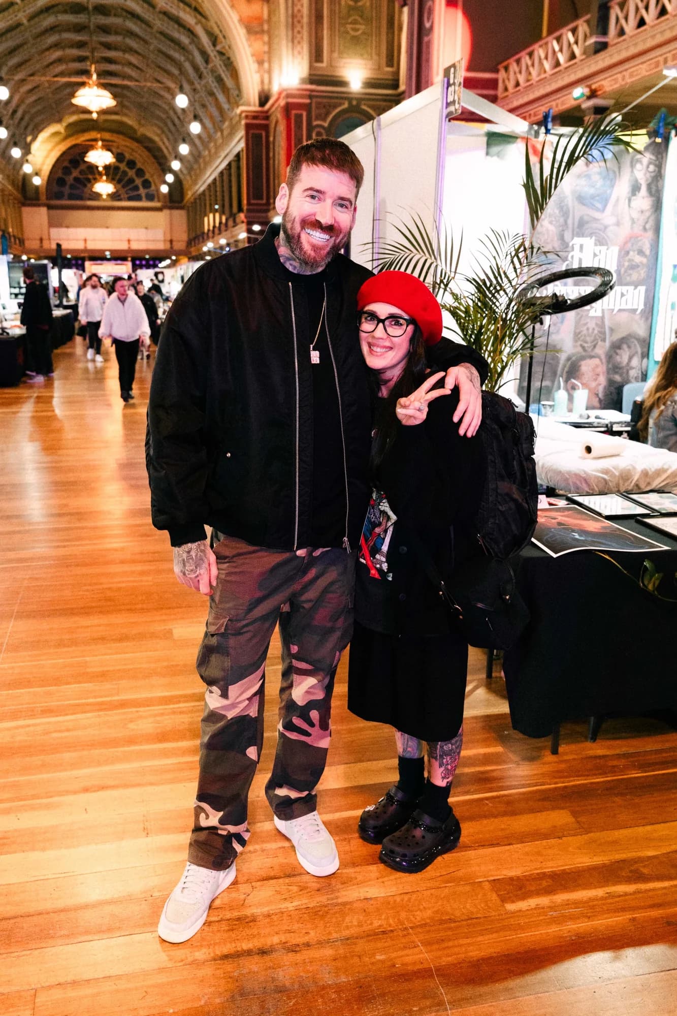 Kevin Mack with his arm around a woman in a red beret on the festival floor