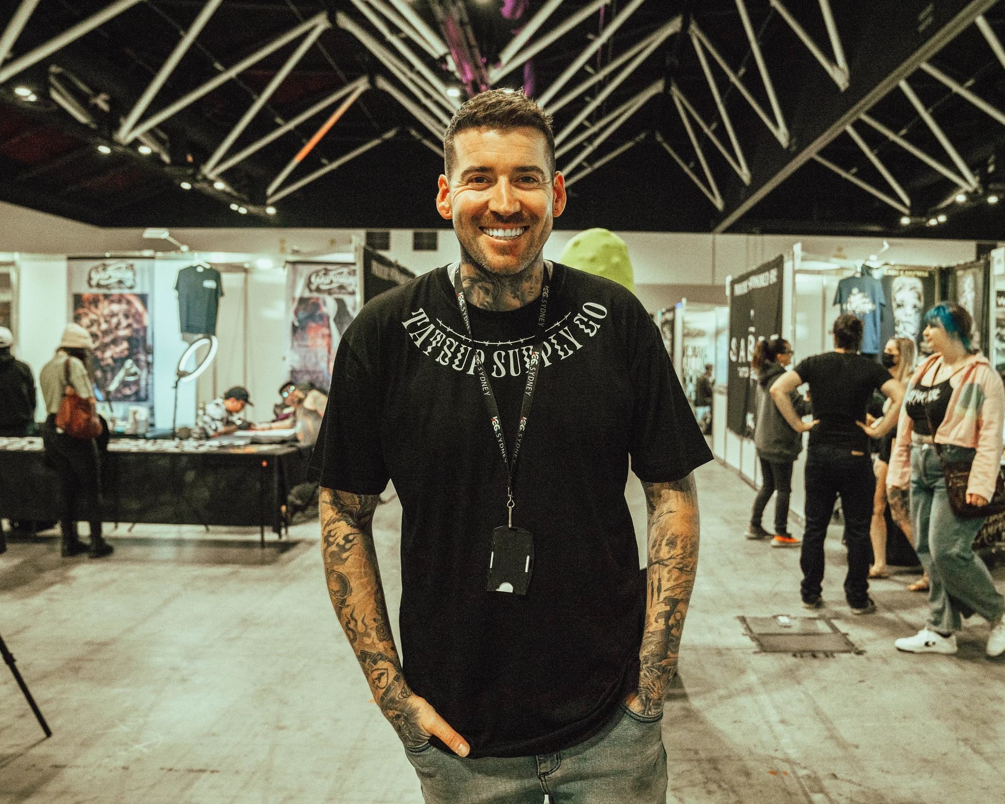 Kevin Mack smiling on the floor of an exhibition