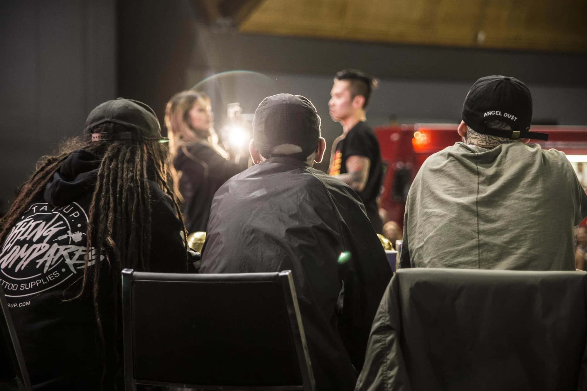 Tattoo artists at work under the lights at Rites of Passage, 2016