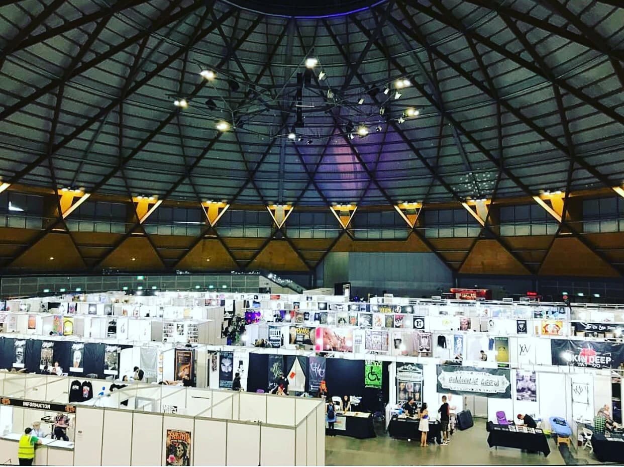 Exhibition stands laid out beneath a domed roof, seen from above